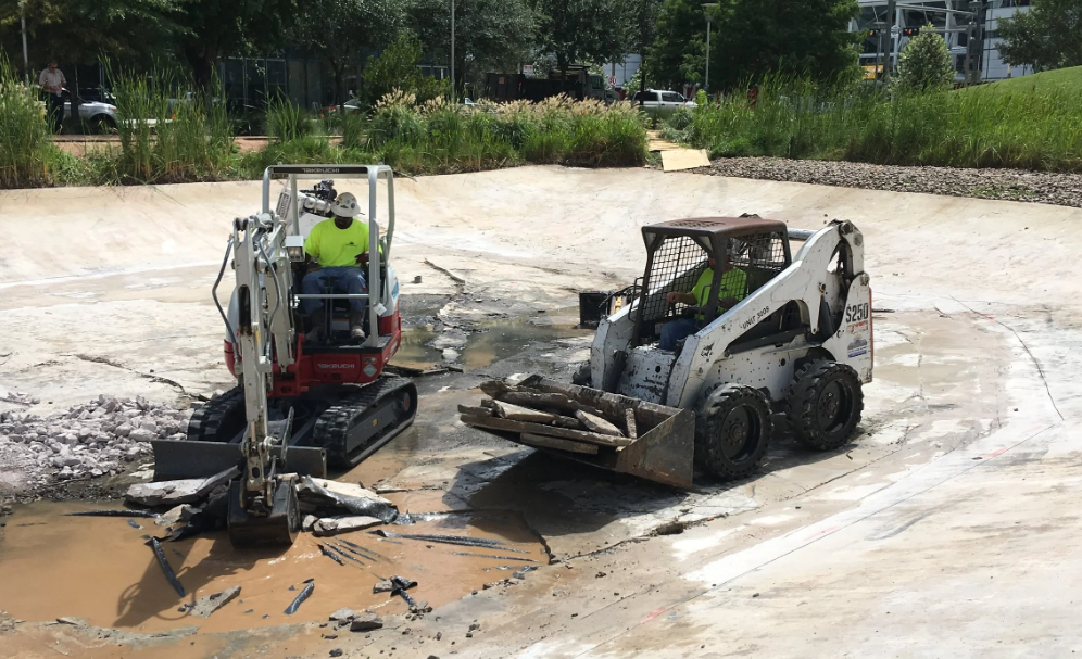 Excavator grading commercial job site — Marek Sawing & Drilling (1)